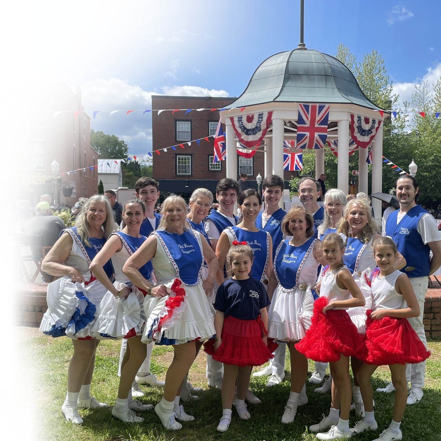 Bull Run Cloggers performing on stage in red, white, and blue costumes.